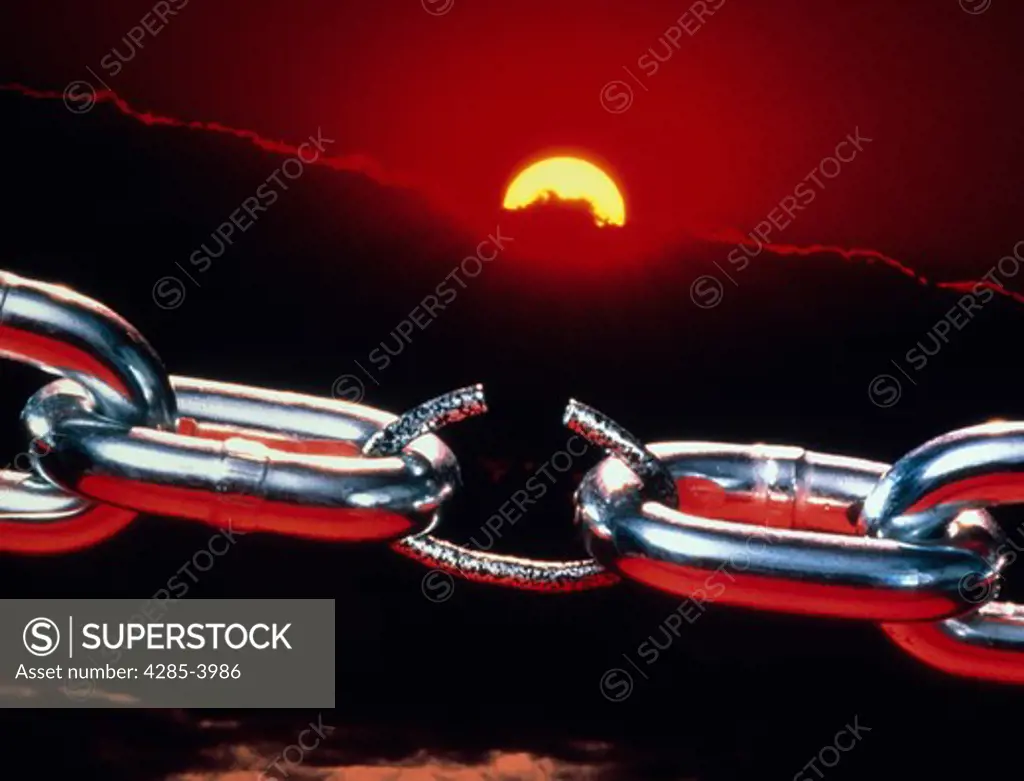 Weak link in the chain breaking with sunset in the background.