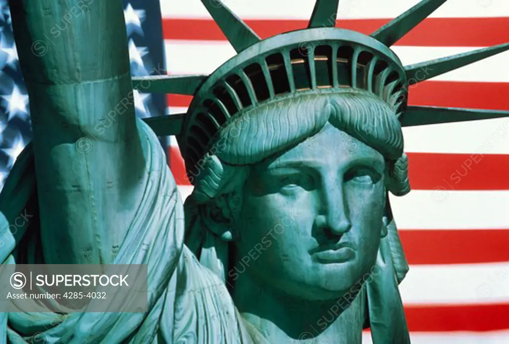 Composite image of a close-up of the face and upraised arm of the Statue of Liberty and an American flag background.