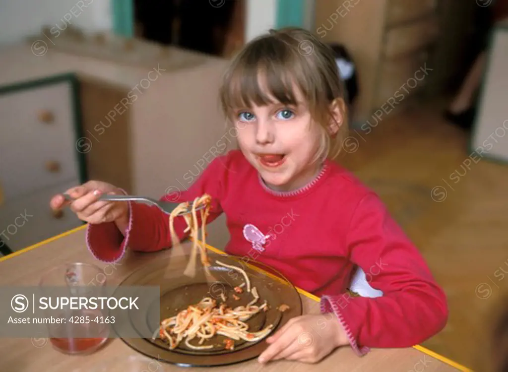 Girl eating spaghettii, kindergarten,  MR9034