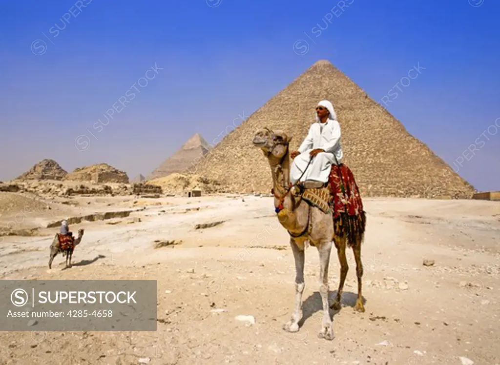 Egyptian on camel by Cheops Pyramid, Egypt