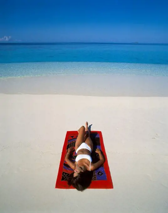 Girl Lying on Tropical Beach in the Maldive Islands, Indian Ocean