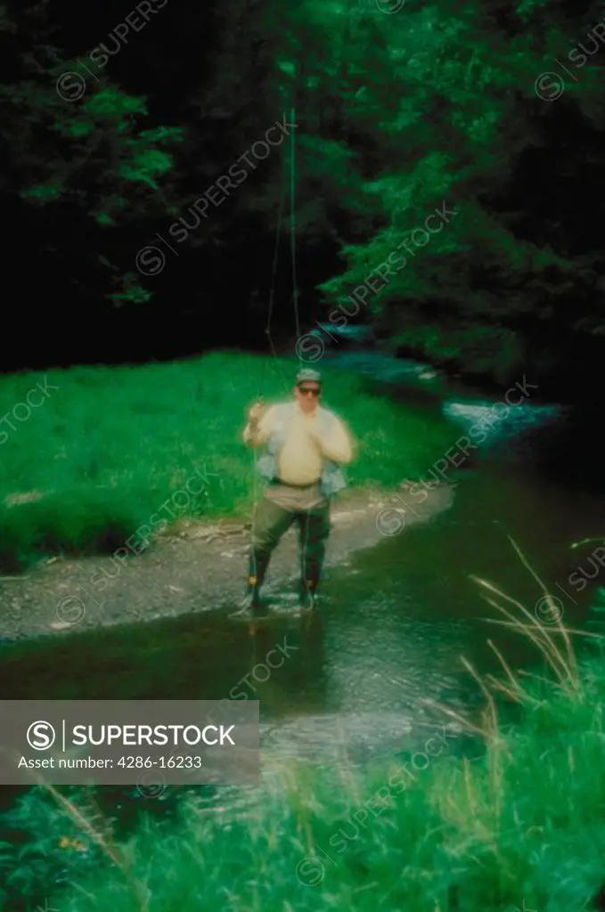Man fishing in stream
