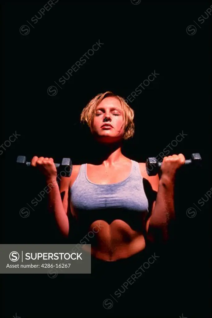Woman excercises with free-weights, MR