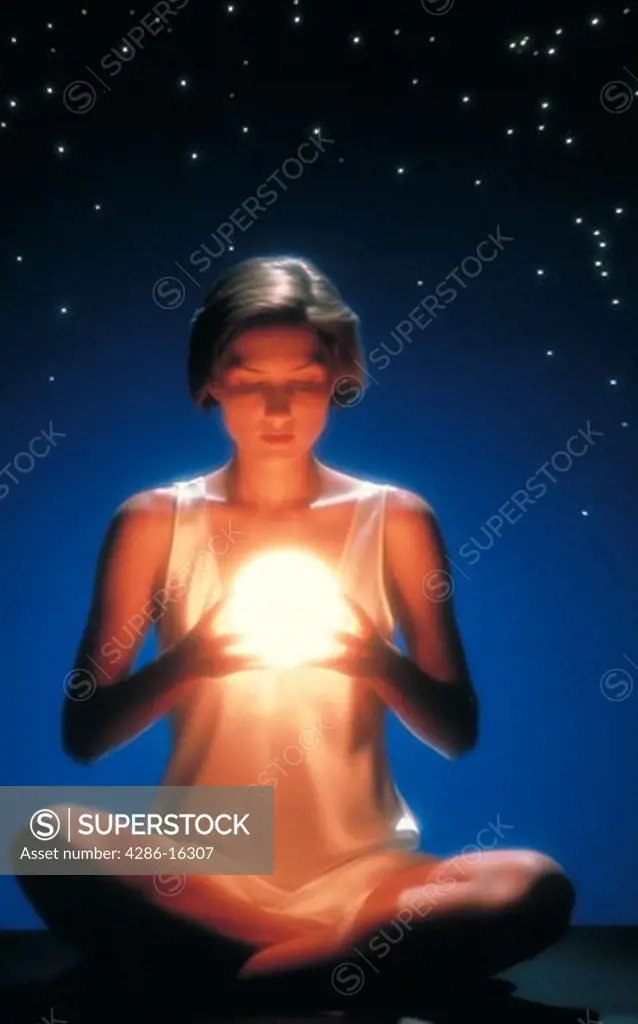 Woman holding glowing ball