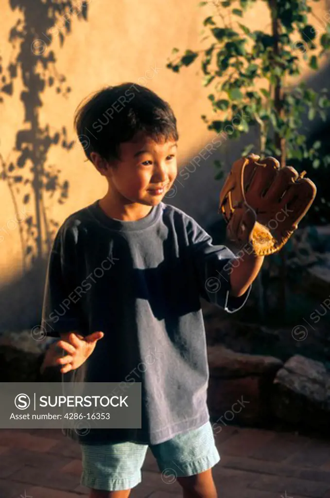 Young asian boy with baseball glove.
