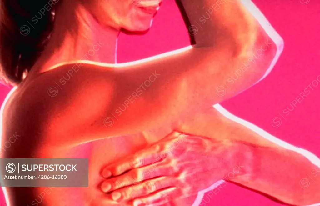 Side view of a woman perfoming a self breast exam, with computer effect.