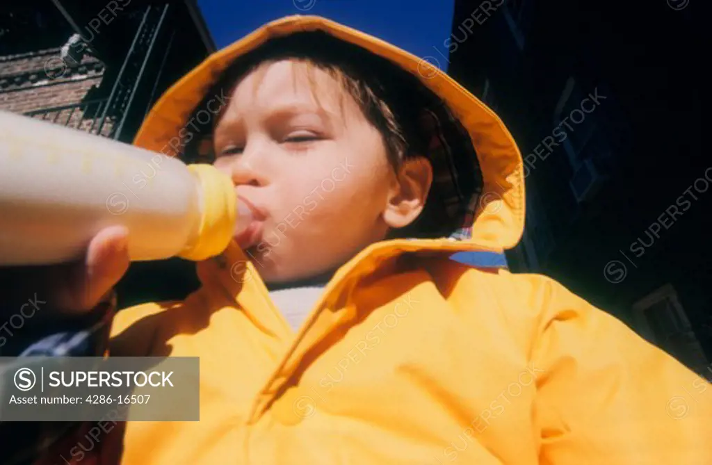 Baby drinks milk from bottle.