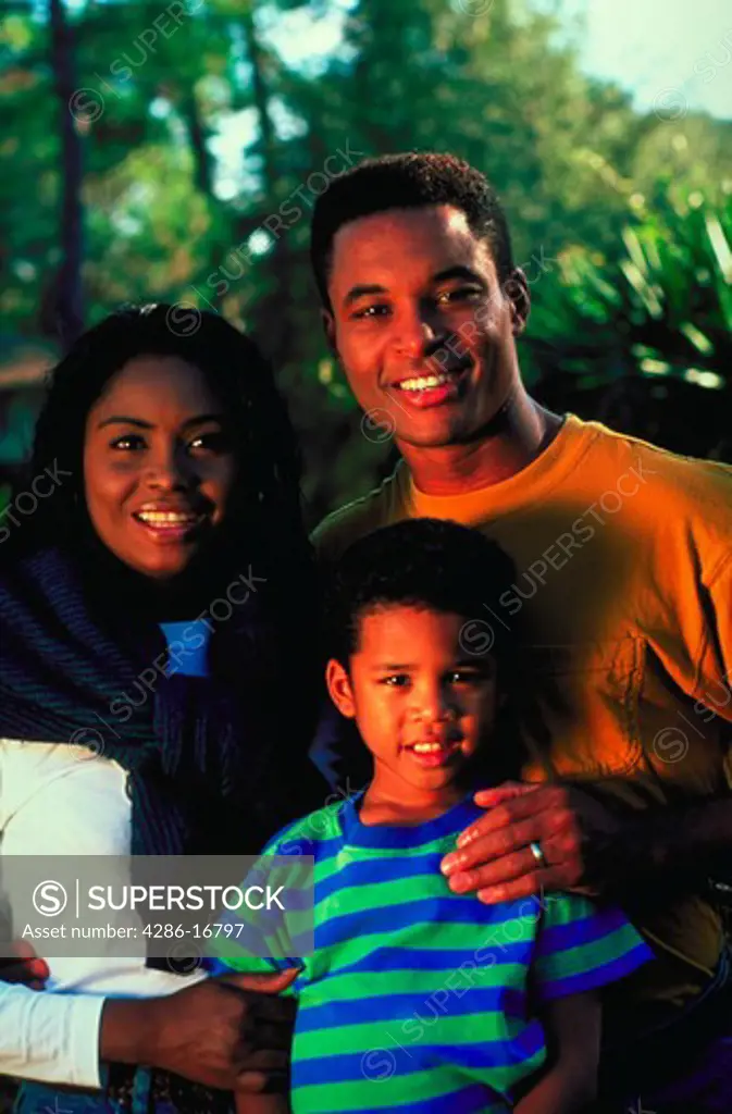 Portrait of a young African-American couple and their son.