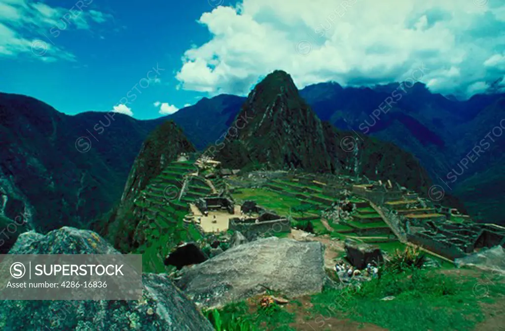 Aerial view of the ancient ruins at Machu Picchu and the surrounding mountains in Peru.