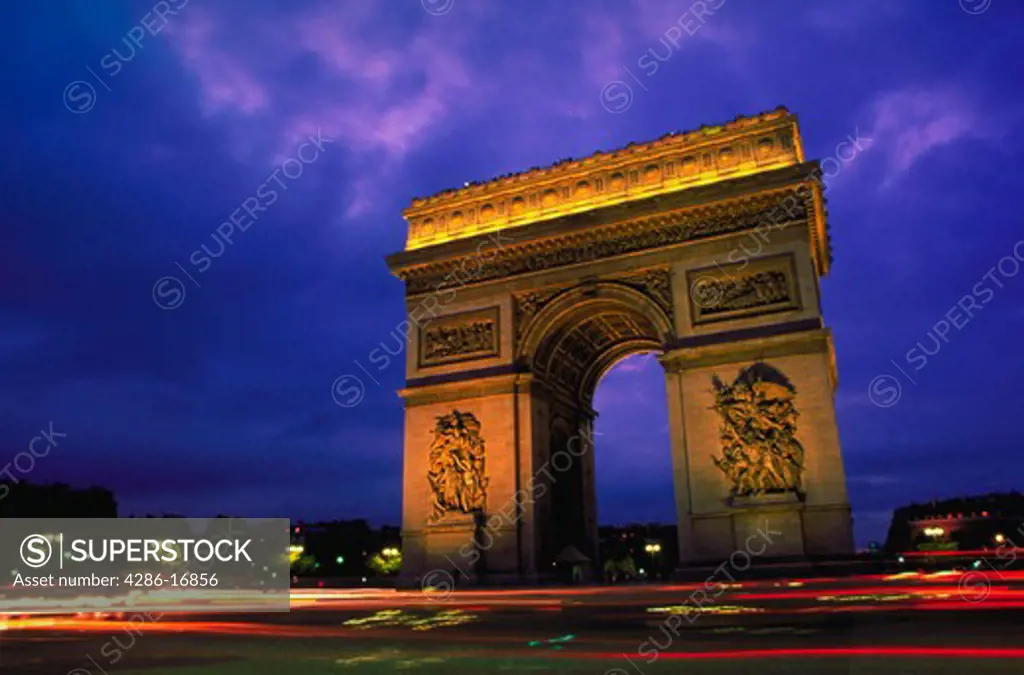 View of the Arc de Triumph at dusk in Paris, France.
