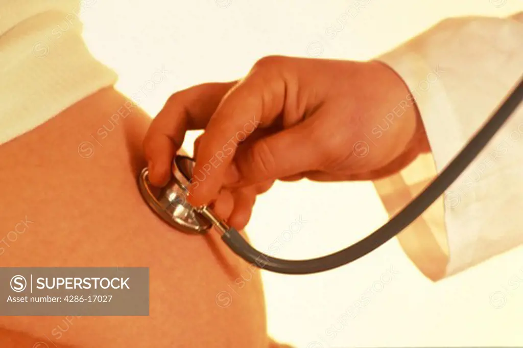 Pregnant woman gets medical exam.