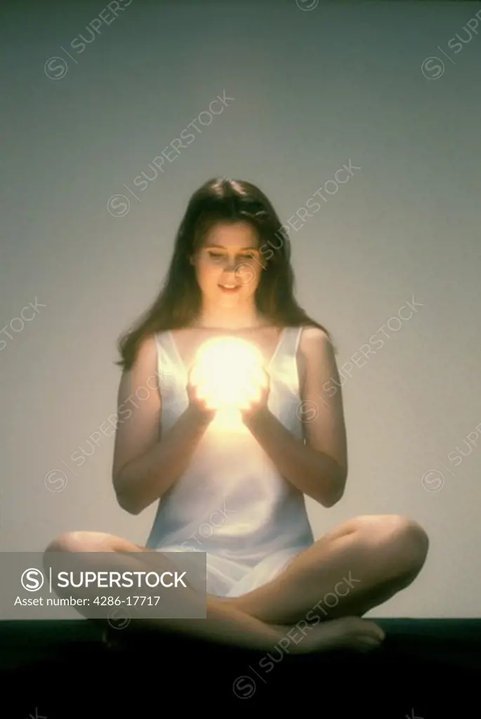 Woman gazes into crystal ball #E4F