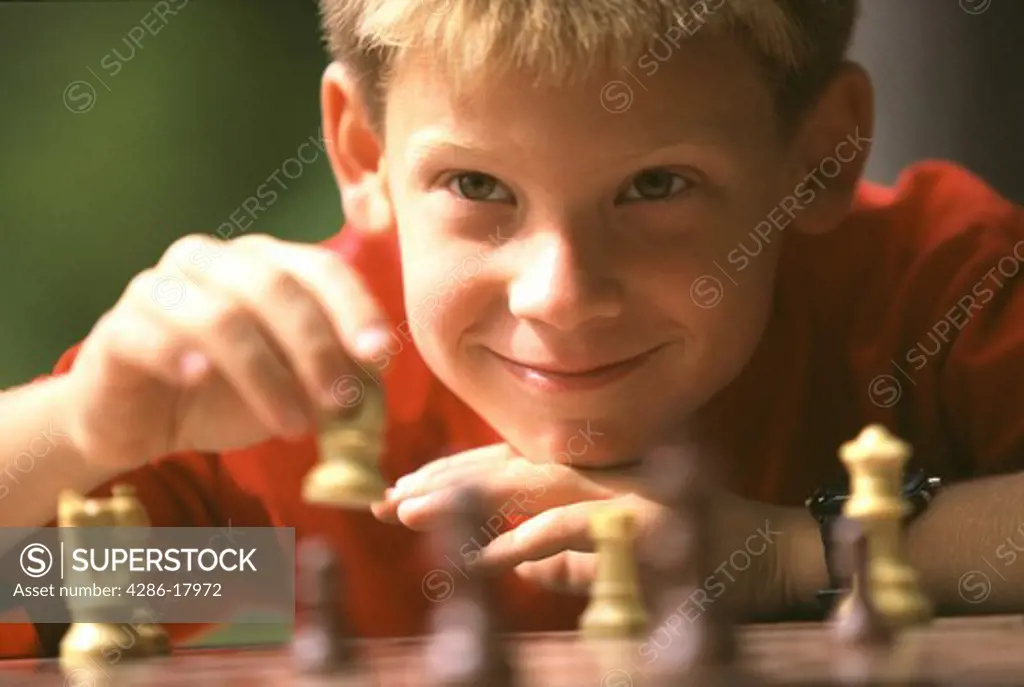 Boy plays chess.