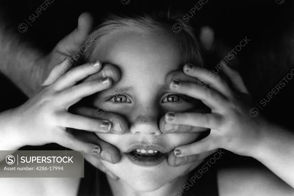 Girl with hands on face.