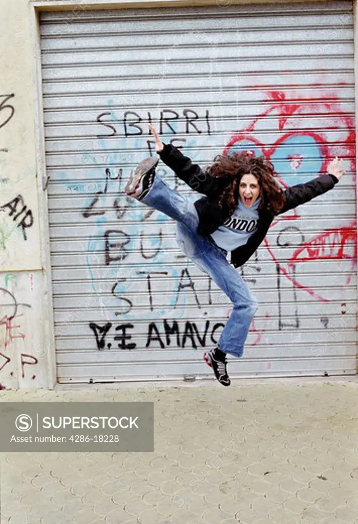 Jumping, excited urban girl.