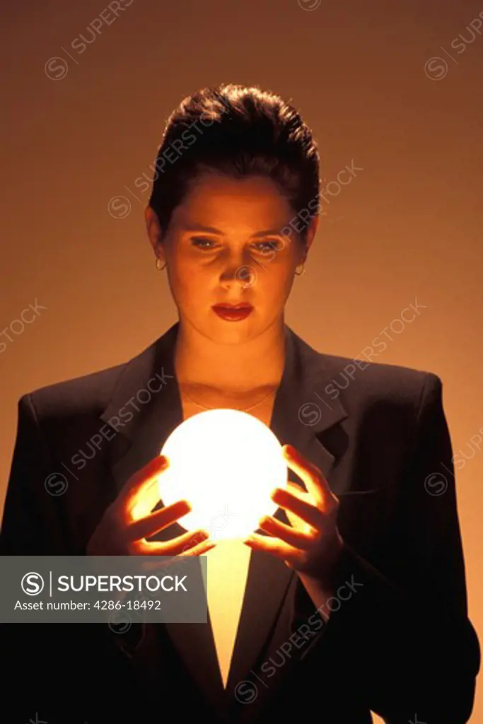 Woman gazes into blowing ball.