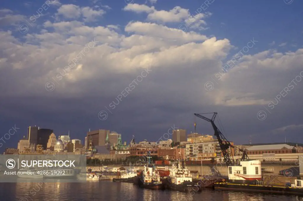 Canada, Quebec, Montreal, Vieux Port and skyline of downtown Montreal on the waters of St. Lawrence River (Fleuve Saint-Laurent) .