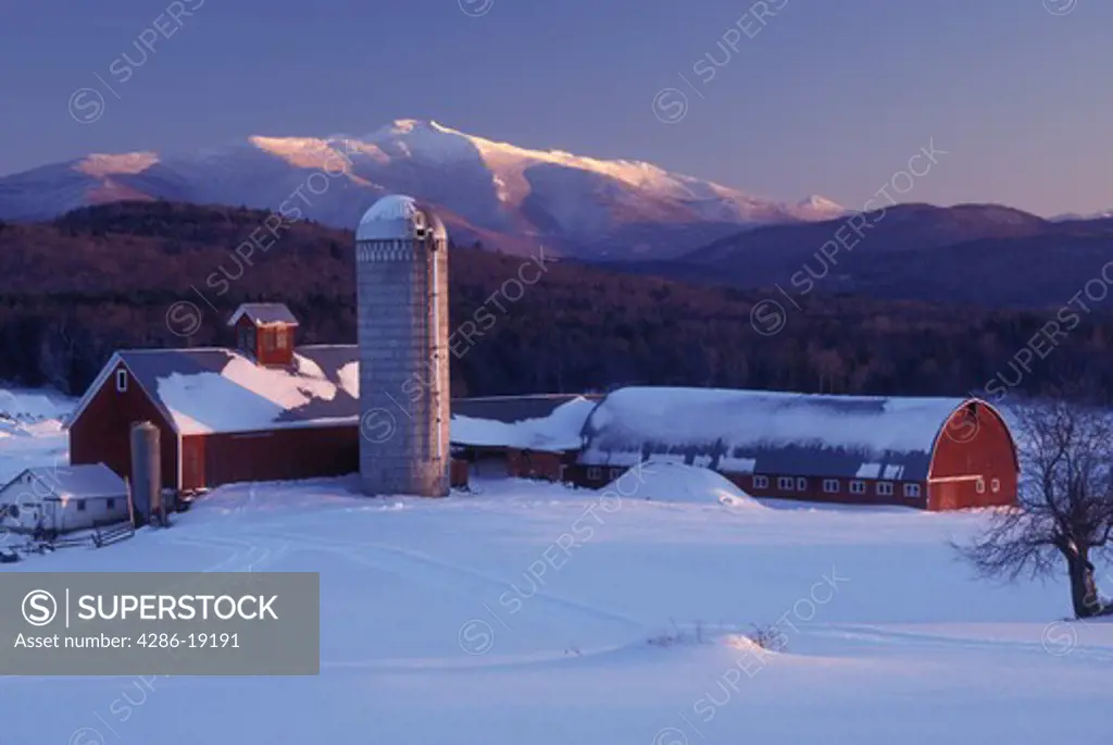 Vermont, barn, farm, Scenic view of Mt. Mansfield and a red barn at Tinker Farm in the early evening light of winter in Fletcher. 