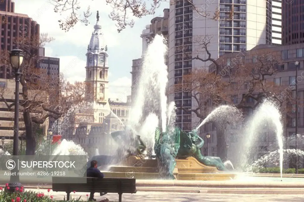 Philadelphia, Pennsylvania, Fountain at Logan Circle and view of City Hall in downtown Philadelphia, Pennsylvania. The fountain was cast by Alexander Stirling Calder.