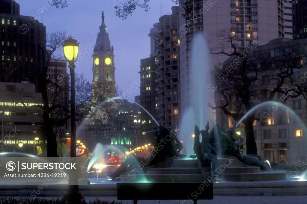 Philadelphia, Pennsylvania, Fountain at Logan Circle with City Hall in the background in the evening indowntown Philadelphia, Pennsylvania. The fountain was cast by Alexander Stirling Calder.