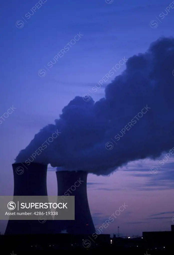 nuclear power plant, Pennsylvania, Steam rises from the cooling towers of the Philadelphia Electric Co. nuclear power plant against a dark blue sky in Limerick in the evening.