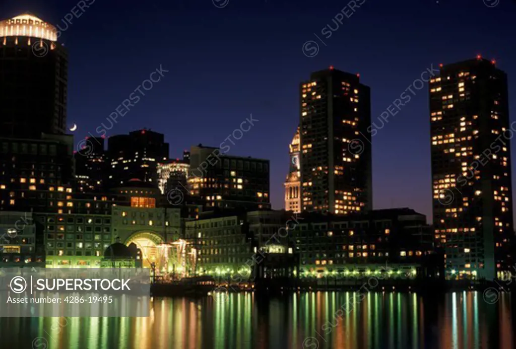 Boston, skyline, downtown, Massachusetts, The lights of the downtown skyline of Boston reflects in the calm waters of the Boston Harbor at night in the state of Massachusetts. 