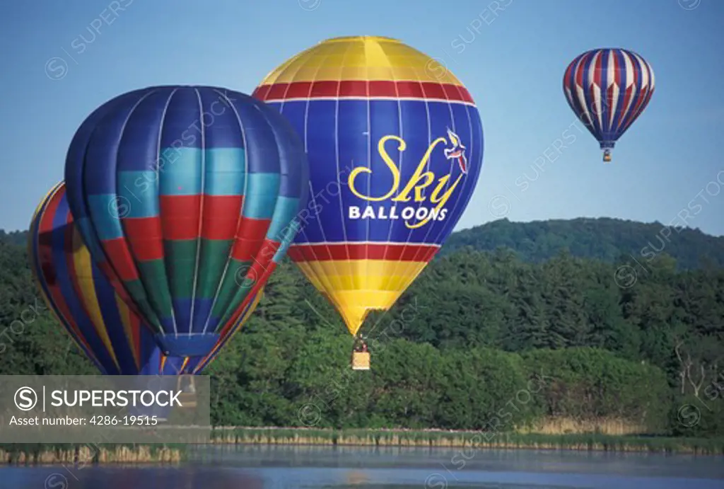 hot air balloon, Vermont, VT, Quechee, Hot air balloons hover above the calm water at the Quechee Hot Air Balloon Festival.