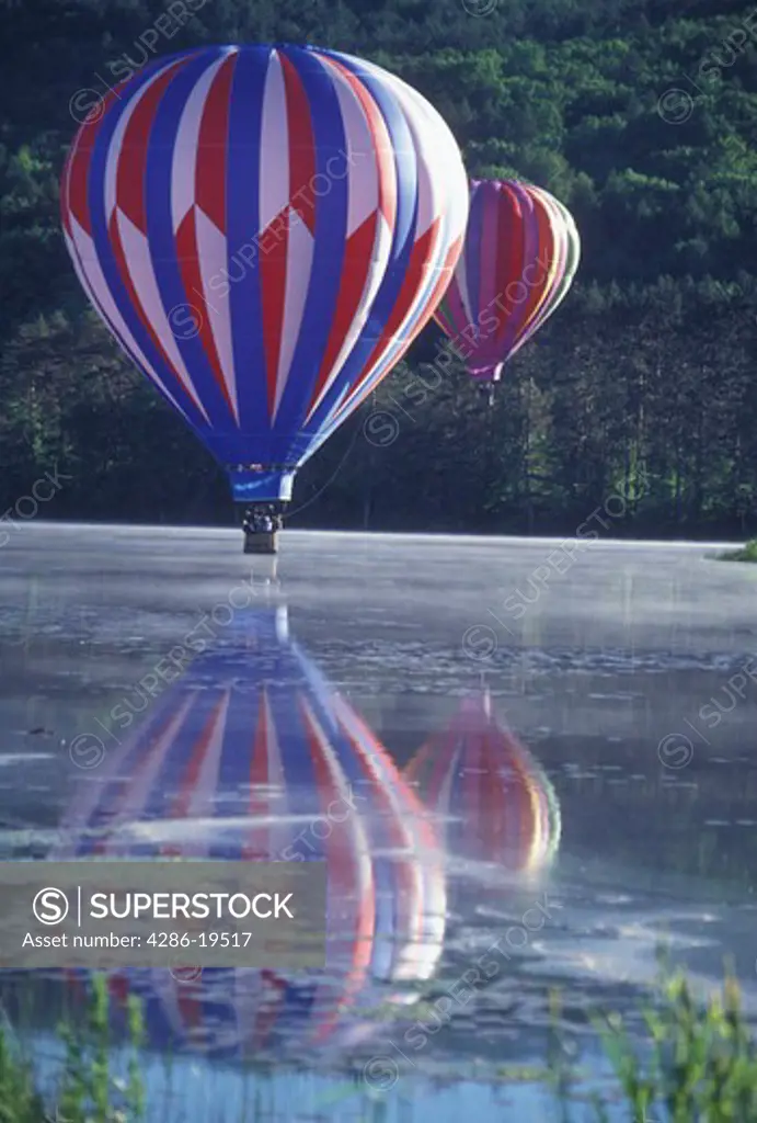 hot air balloon, Vermont, VT, Quechee, Hot air balloons touch down into the misty water at the Quechee Hot Air Balloon Festival.