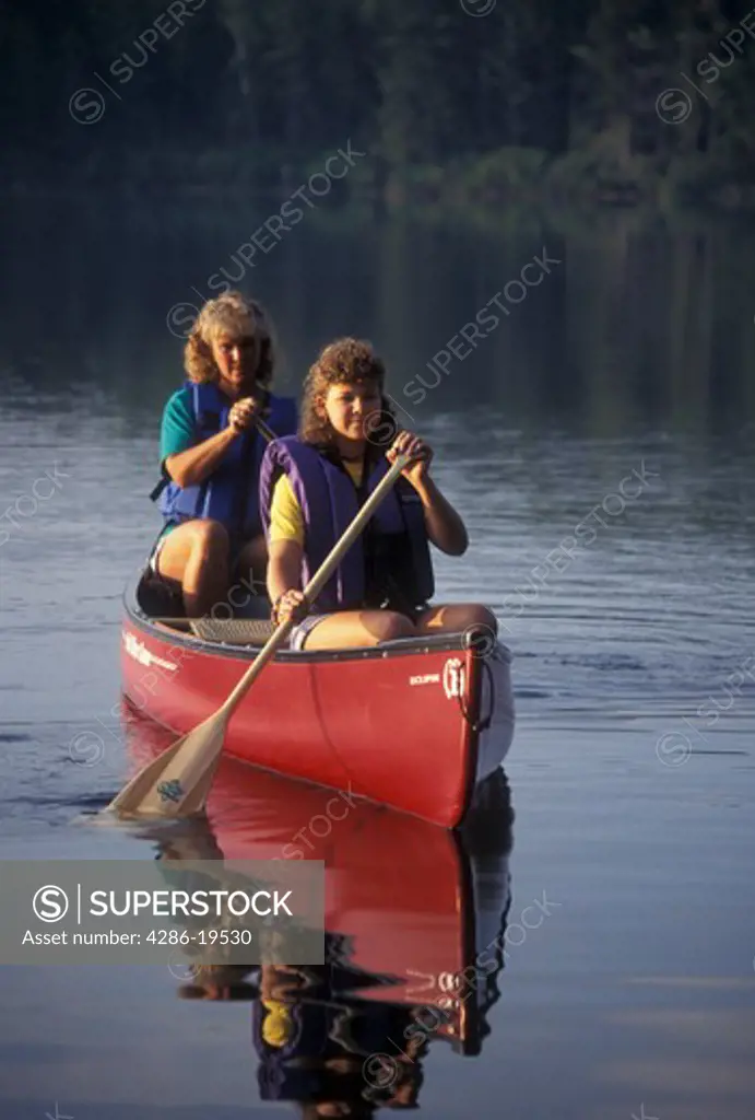 canoeing, canoe, Vermont, VT, Mother and daughter paddling a red canoe on Kettle Pond in Groton State Forest.