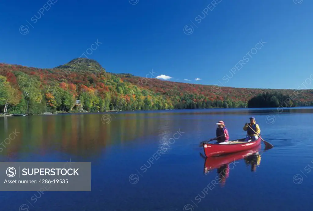 canoe, canoeing, Vermont, VT, Mother and daughter paddle a red canoe on Long Pond in Westmore in the fall. 