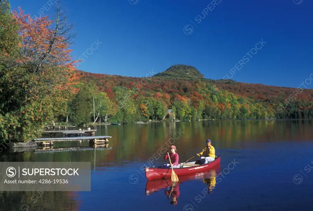 canoeing, canoe, Vermont, VT, Mother and daughter paddling a red canoe on Long Pond in Westmore in the fall. 