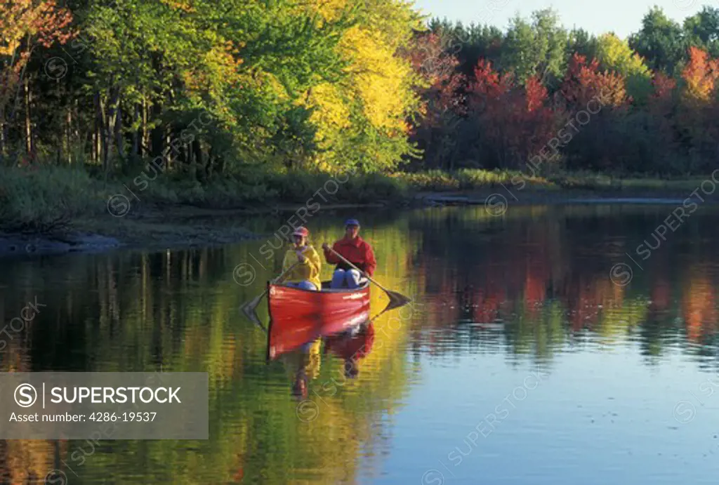 canoeing, canoe, Vermont, VT, Mother and daughter paddling a red canoe down Clyde River in Charleston in the fall. 