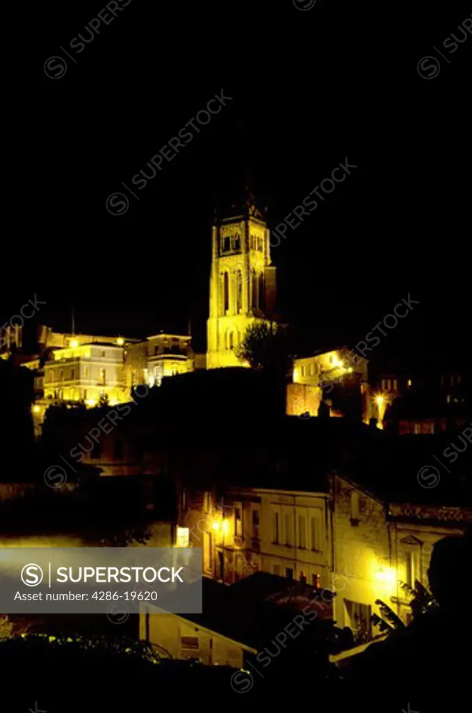 Saint Emilion, Aquitaine, Europe, Bordeaux Wine Region, Gironde, France, The medieval village of St. Emilion and Eglise Monolithe illuminated at night.