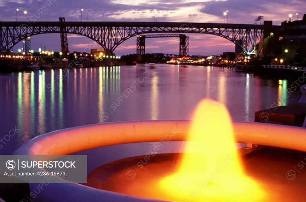 fountain, bridge, Cleveland, OH, Ohio, Flats District, Fountain at Settlers Landing Park along the Cuyahoga River in the Flats District of downtown Cleveland illuminated at night. Main Avenue Bridge crossing the Cuyahoga River in the background.