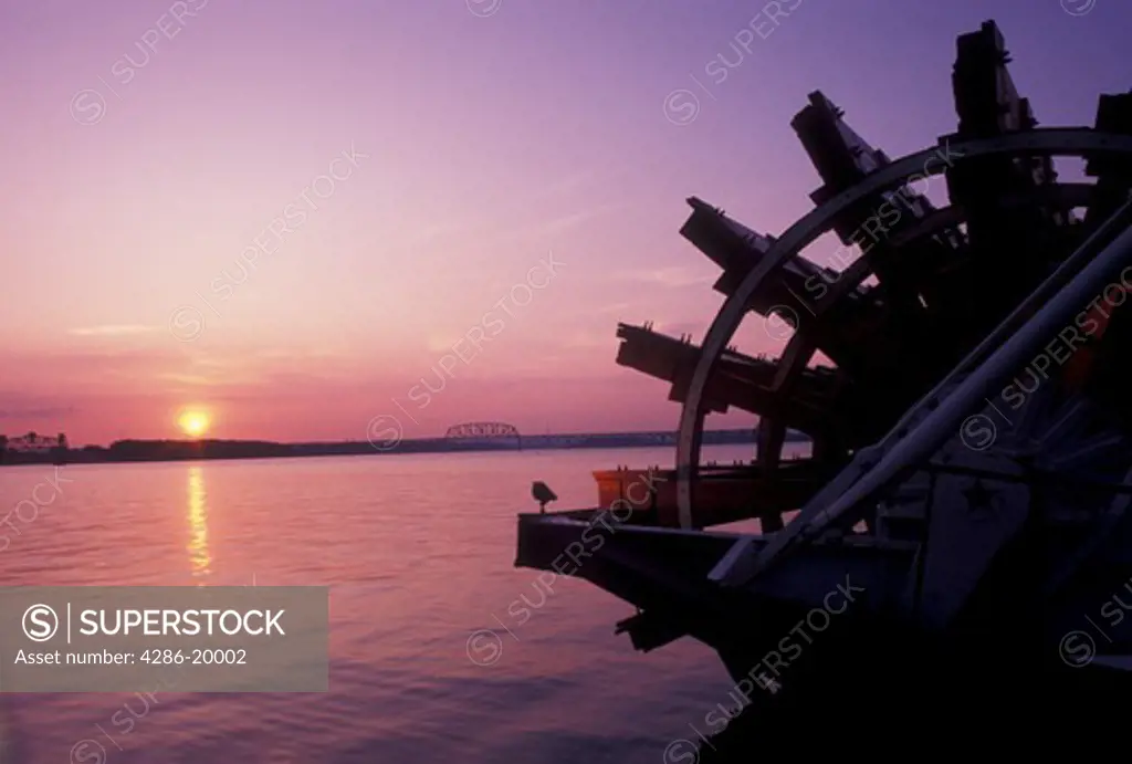 sunset, Louisville, KY, riverboat, Kentucky, Ohio River, Silhouette of the paddle wheel on the Belle of Louisville Riverboat docked along the Ohio River at sunset. 