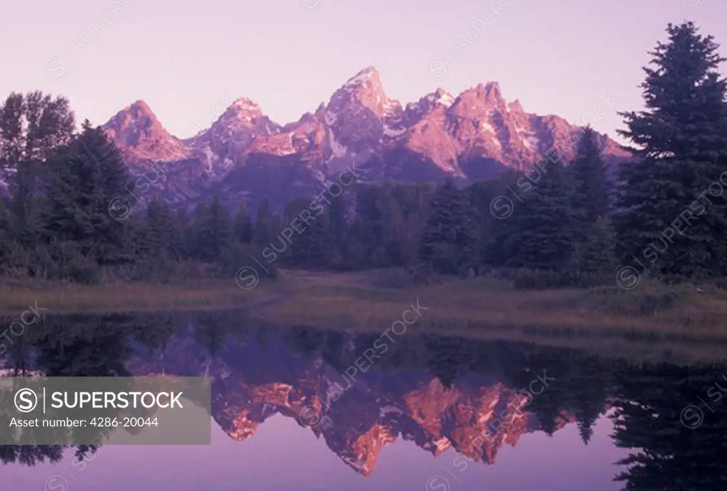 Grand Teton National Park, Snake River, Jackson Hole, WY, Wyoming, Scenic view of the Grand Teton Mountains reflecting in the calm waters of the Snake River at sunrise in Grand Teton Nat'l Park in Wyoming.