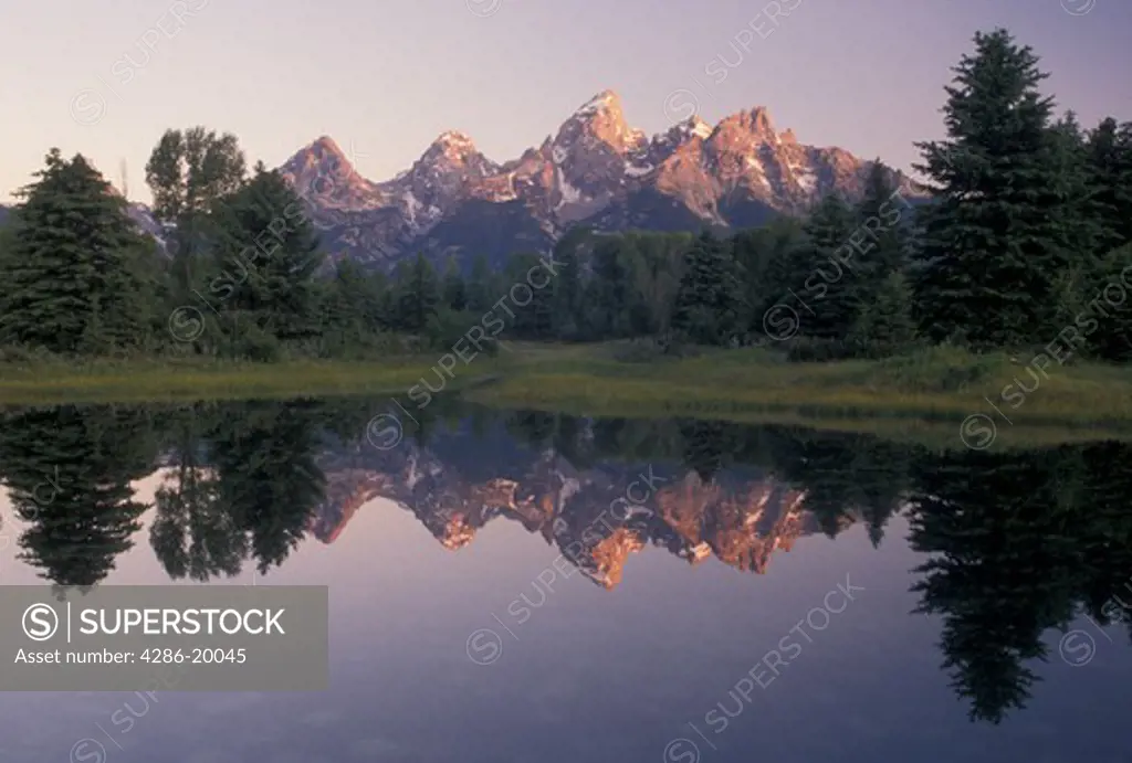 Grand Teton National Park, Snake River, Jackson Hole, WY, Wyoming, Scenic view of the Grand Teton Mountains reflecting in the calm waters of the Snake River at sunrise in Grand Teton Nat'l Park in Wyoming.