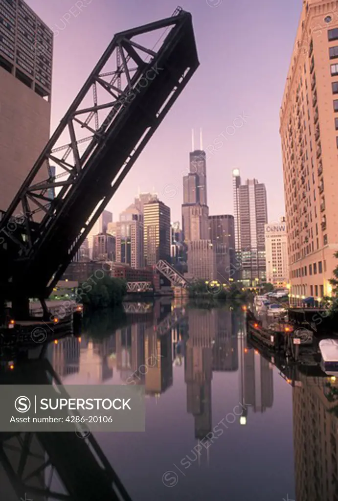 Chicago, drawbridge, skyline, IL, Illinois, Chicago River, A drawbridge in the up position shows the skyline of downtown Chicago reflecting in the Chicago River at sunrise.