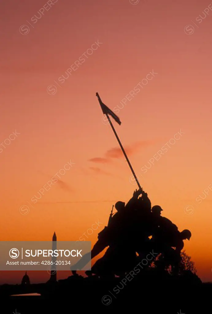 Marine Corps Memorial, Iwo Jima, sunrise, Arlington, VA, Arlington National Cemetery, Virginia, Silhouette of the U.S. Marine Corps Memorial, Iwo Jima, at the Arlington Nat'l Cemetery with the Washington Monument and US Capitol Building in the distance at sunrise.