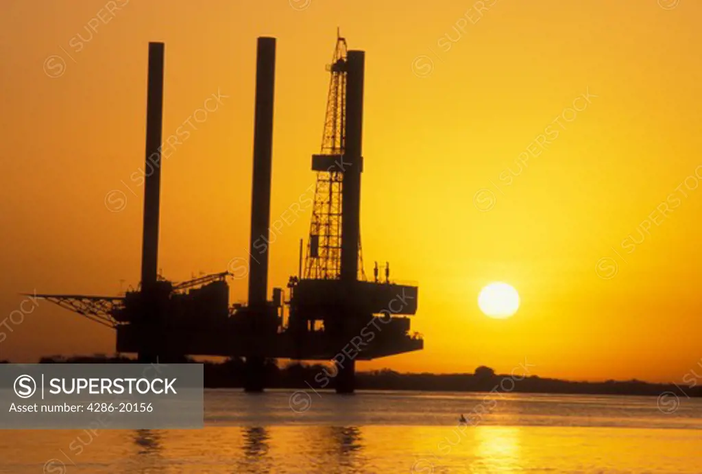 oil rig, Port Arthur, TX, Texas, Gulf of Mexico, Silhouette of an offshore oil rig at sunrise of the Gulf of Mexico in Port Arthur.