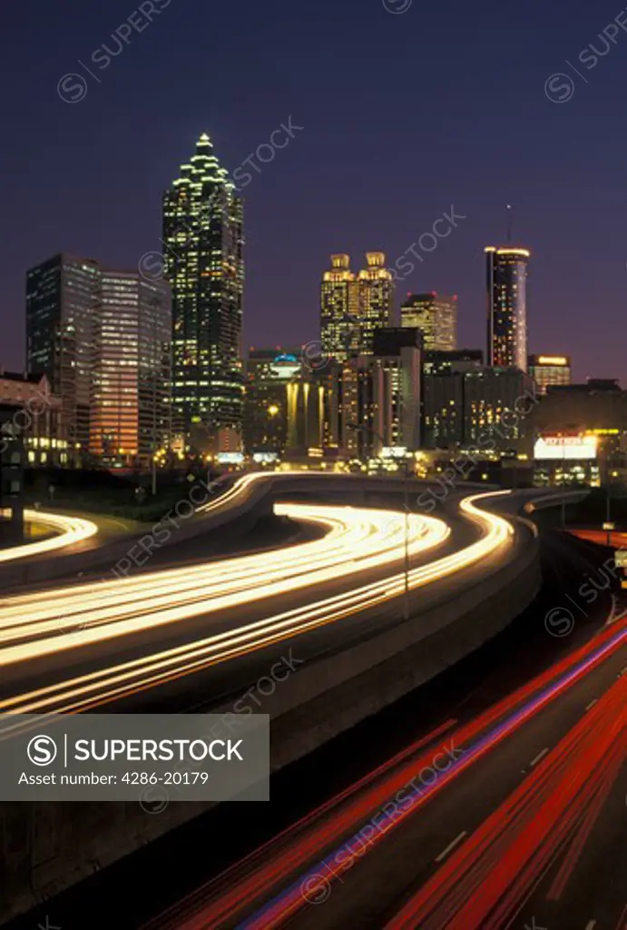 skyline, Atlanta, GA, Georgia, Traffic lights streak on I-75/I-85 at sunset and view of the skyline of downtown Atlanta.
