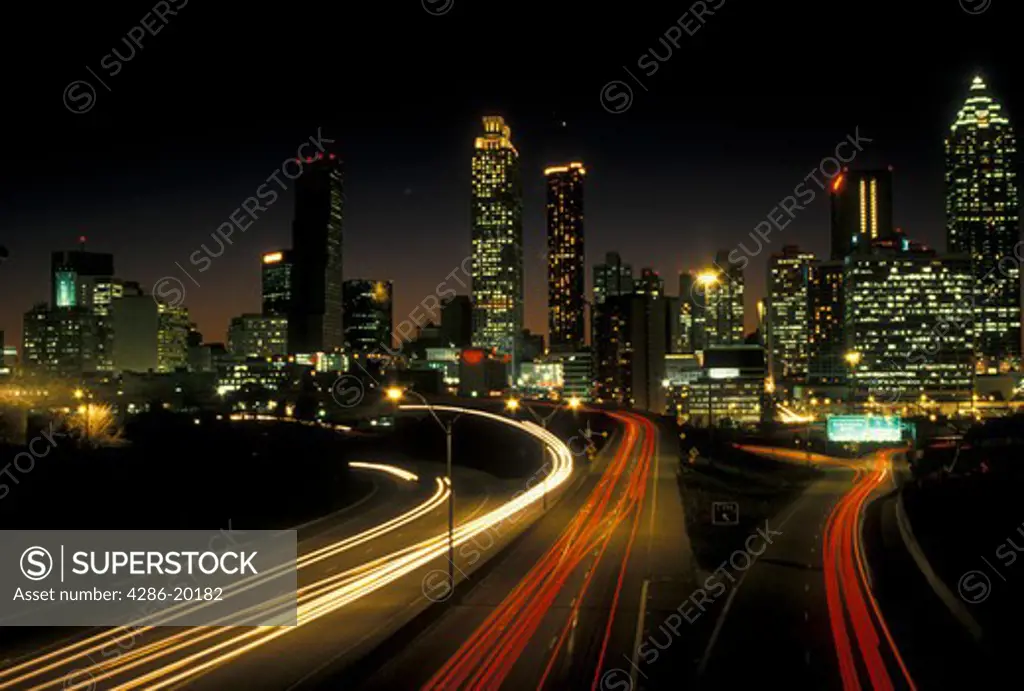 skyline, Atlanta, GA, Georgia, Traffic lights streak on Freedom Parkway in the evening and skyline of downtown Atlanta.