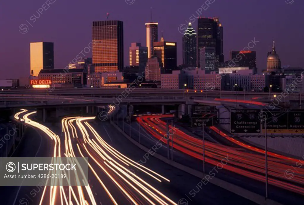 skyline, Atlanta, GA, Georgia, Traffic lights streak on I-75/I-85 at sunset and view of the skyline of downtown Atlanta.