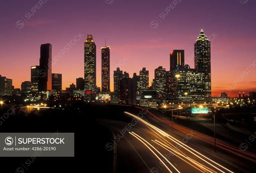 traffic, road, skyline, Atlanta, GA, Georgia, Traffic lights streak on Freedom Parkway at sunset and view of the skyline of downtown Atlanta.
