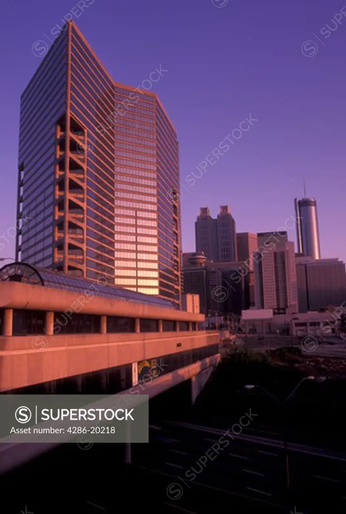 Atlanta, skyline, GA, Georgia, Skyline of downtown Atlanta. Downtown Connector I-75/85 passes under the MARTA station at sunset.