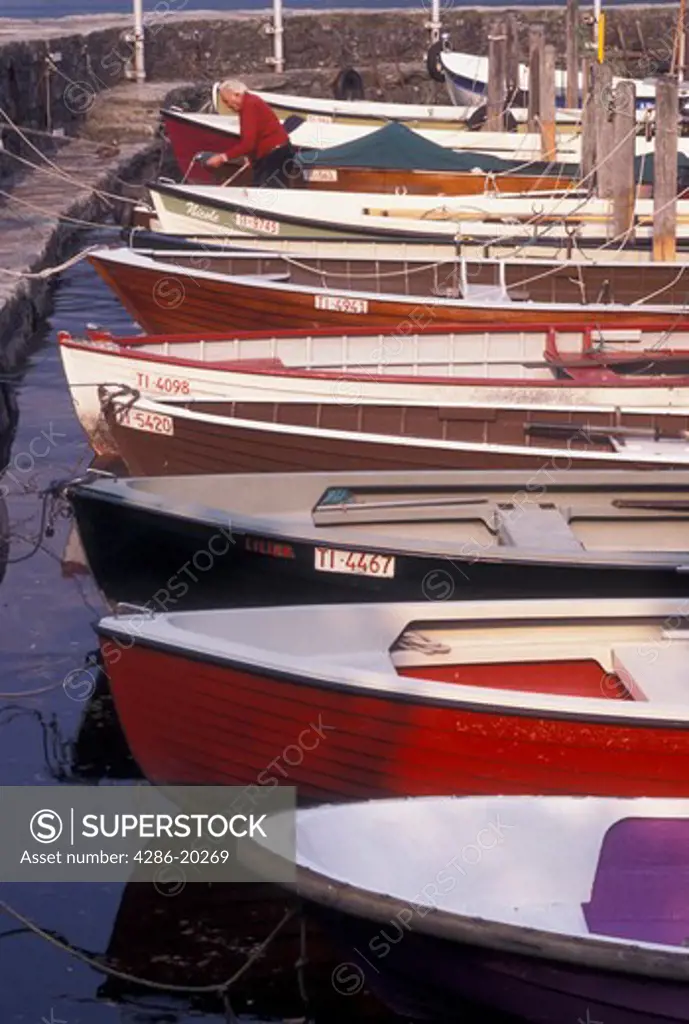 Switzerland, Ticino, Ascona, Rowboats docked in the harbor along the lakefront of Lake Maggiore in the city of Ascona.