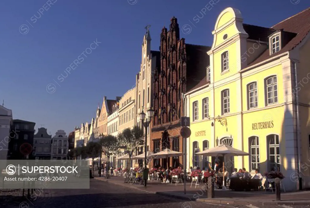 Germany, Wismar, Europe, Mecklenburg-Pomerania, Outdoor cafs and gabled buildings at Markt in downtown Wismar
