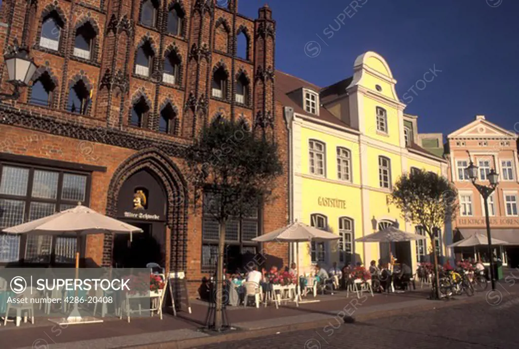 Germany, Wismar, Europe, Mecklenburg-Pomerania, Outdoor cafs and gabled buildings at Markt in downtown Wismar