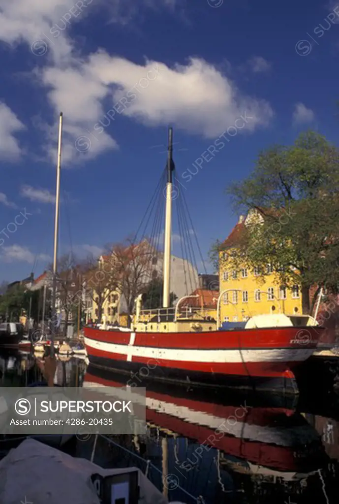 Copenhagen, Denmark, Scandinavia, Sjaelland, Europe, Large red and white sailboat (flagship) docked along a canal in the scenic city of Copenhagen. 