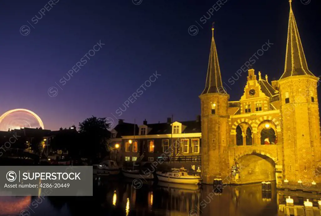 Netherlands, Sneek, Holland, Friesland, Europe, Water Tower (1613) along the canal in downtown Sneek illuminated at night.
